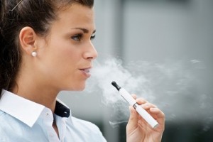 young woman smoking electronic cigarette outdoor office building