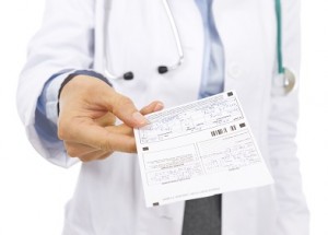 Closeup on doctor woman giving prescription