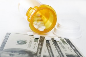 Prescription bottle and pills with hundreds of dollar bills